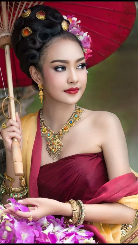 beautiful thai girl in thai traditional costume she smile and looking high asian girl