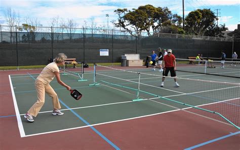 Singles tennis is played with 2 players who line up on opposite sides of the net. Pickleball catching on in Newport - Daily Pilot