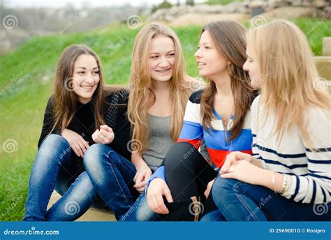 Four Happy Teen Girls Friends Having Fun Outdoors Stock Photo