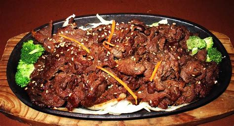 Traditional bulgogi is served with a variety of pickled and fresh vegetables and wrapped in lettuce wraps. Bulgogi is Korean barbeque, it is a sweet, tangy meat dish ...