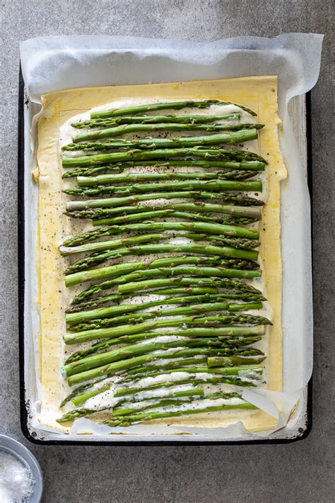 Top the puff pastry with grated cheese, followed by sauteed mushrooms. Cheesy puff pastry asparagus tart - Simply Delicious