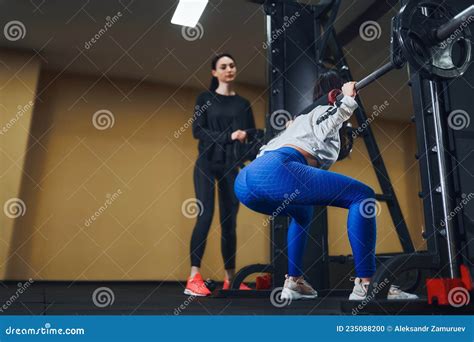Brunette Sport Woman Working Out Legs With Barbell In Gym Personal