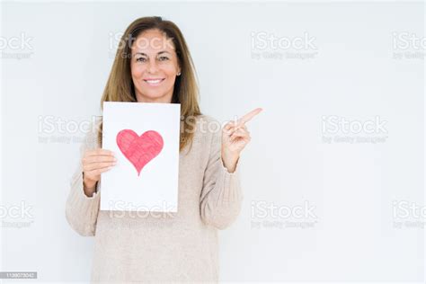 중간 나이 여자 지주 카드 선물 빨간색 마음으로 고립 된 배경 매우 행복 측면에 손과 손가락을 가리키는 가리키기에 대한 스톡 사진 및 기타 이미지 Istock