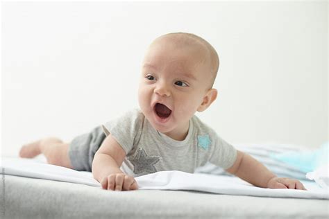 Baby Expressing Happiness By Stocksy Contributor Miquel Llonch