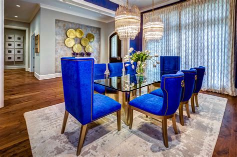 The Bold Blue Walls Brilliant Chandeliers And Plush Custom Dining
