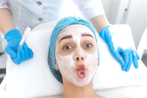 Woman Professional Doctor Beautician Applies A Mask On A Patient`s Face For Skin Care Cosmetic