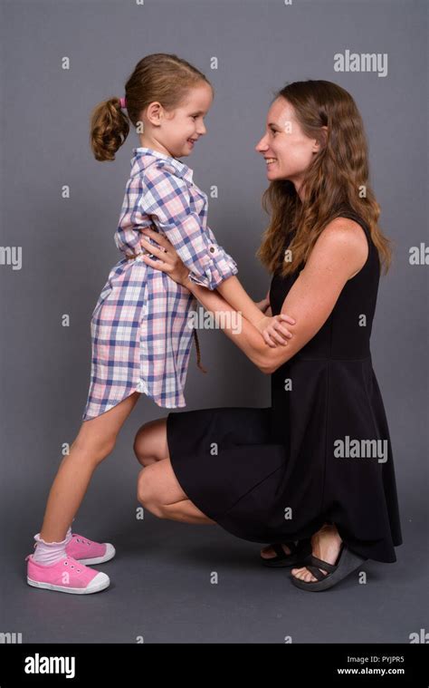 Mother And Daughter Bonding Together Against Gray Background Stock