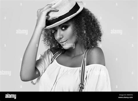 sensual portrait of glamor elegant black hippy woman model with curly hair and hat posing on