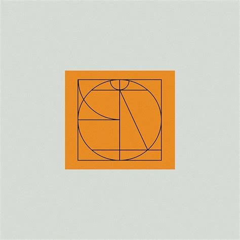 An Orange Square With A Golden Rectangle In The Center On A Gray