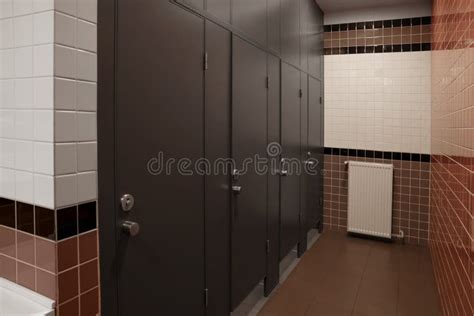 Public Toilet Interior With Stalls And Tiled Walls Stock Photo Image