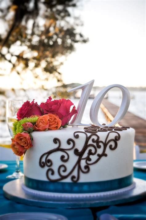 Among the things that increase the love and attention between the couple celebrate their anniversary each year on the same day to bring romantic feelings that collect between them. Anniversary cake with scroll design, blue ribbon and ...