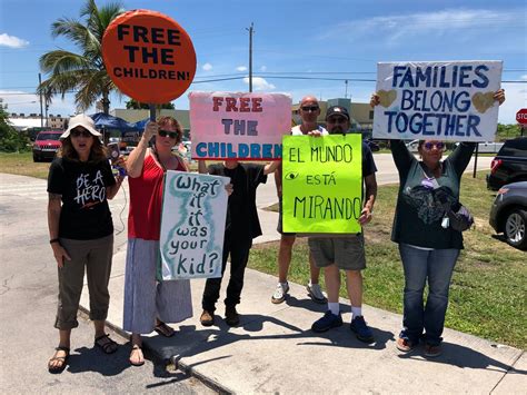Protesters Set Up A Campsite And Wave Signs At Migrant Children In Florida