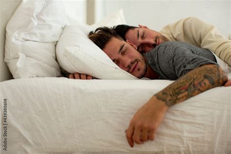 gay couple sleeping on bed together stock foto adobe stock
