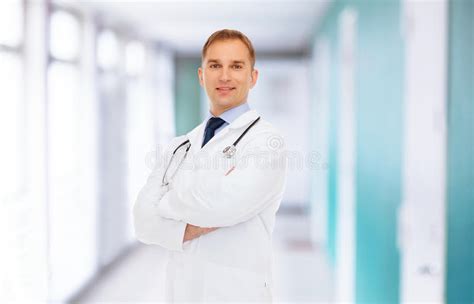 Smiling Male Doctor In Lab Coat With Stethoscope On White Stock Photo