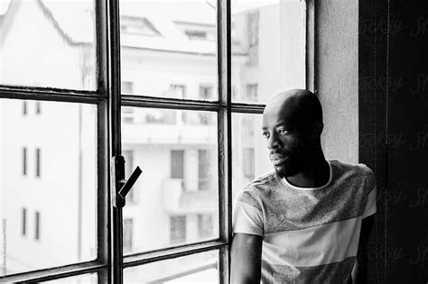 Black And White Portrait Of A Black Man Looking Out Of The Window Del