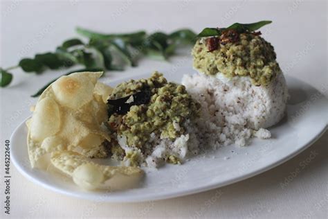 Steamed Rice Cake Served With Green Gram Curry And Papad A Favorite