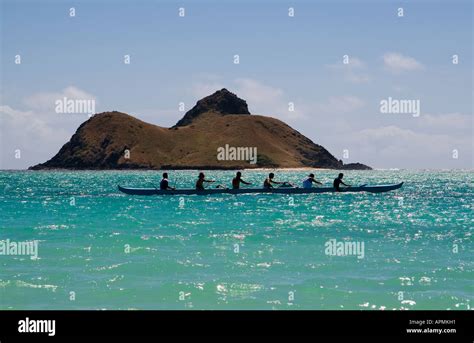 Outrigger Canoe Paddlers Pass One Of The Mokulua Islands Lanikai Oahu
