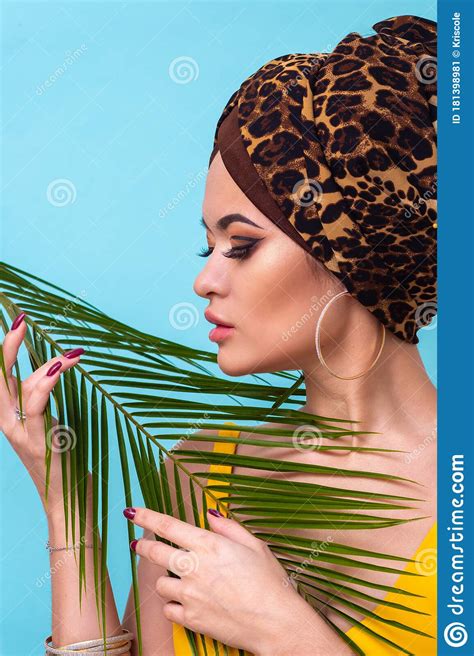 An Attractive Young Woman In A Stylish Turban Made Of Leopard Print