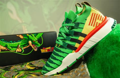 The primeknit upper begins in a vibrant green tone, with darker green hues creating horizontal stripes across the toe box. Are You Copping The Dragon Ball Z x adidas EQT Support Mid ADV Shenron Green? • KicksOnFire.com