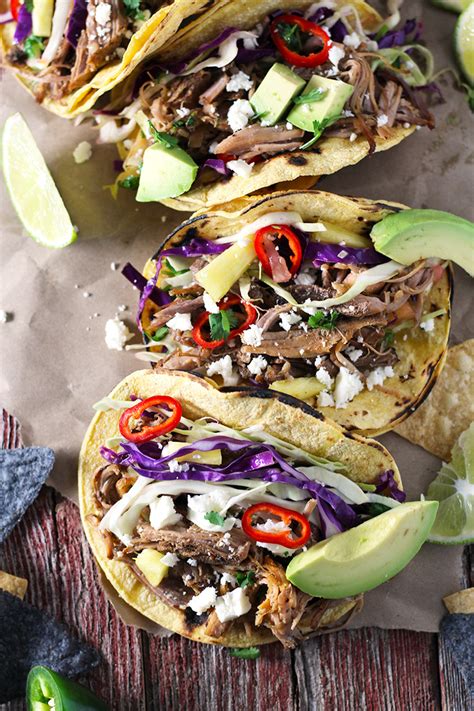 Spoon refried beans onto a plate and top with grated cheese. Pork Carnitas Tacos with Spicy Pineapple Slaw | Modern ...