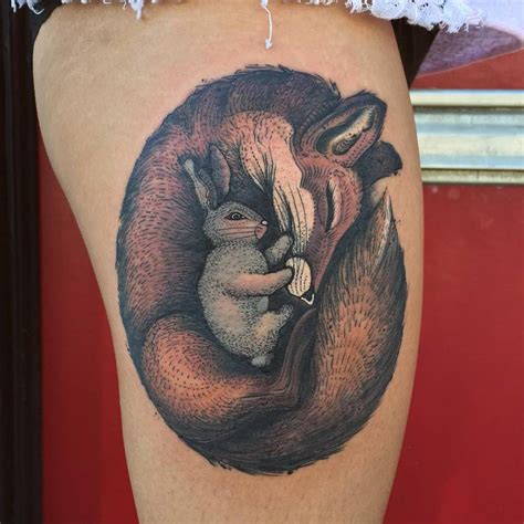 Fox And Rabbit Tattoo On The Right Thigh