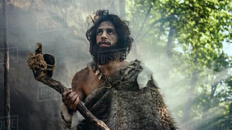Primeval Caveman Wearing Animal Skin Holds Stone Tipped Hammer Comes