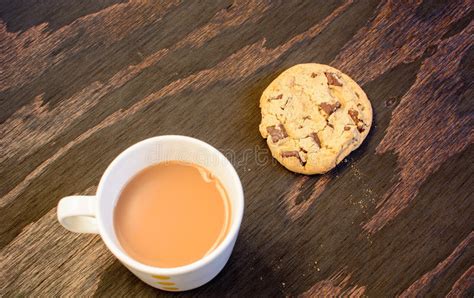A Cup Of Tea And A Chocolate Chip Cookie Stock Photo Image Of