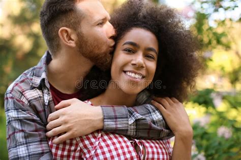 Young Loving Interracial Couple Kissing Outdoors Spring Day Stock