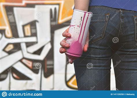 Photo Of A Girl S Hand With Aerosol Paint Cans In Hands On A Graffiti