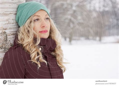 Woman Leaning Against Tree In Winter A Royalty Free Stock Photo From