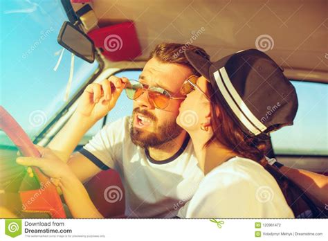 Laughing Romantic Couple Sitting In Car While Out On A Road Trip At