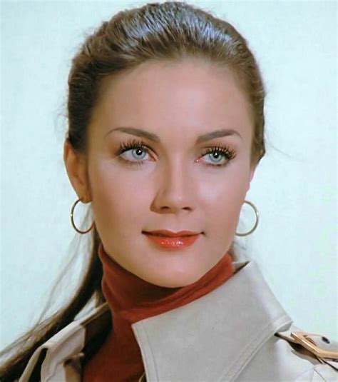 A Close Up Of A Person Wearing Large Hoop Earrings And A Trench Coat