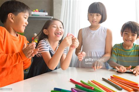 Asian Kids Playing With Play Colorful Clay At Home Or Kindergarten Or