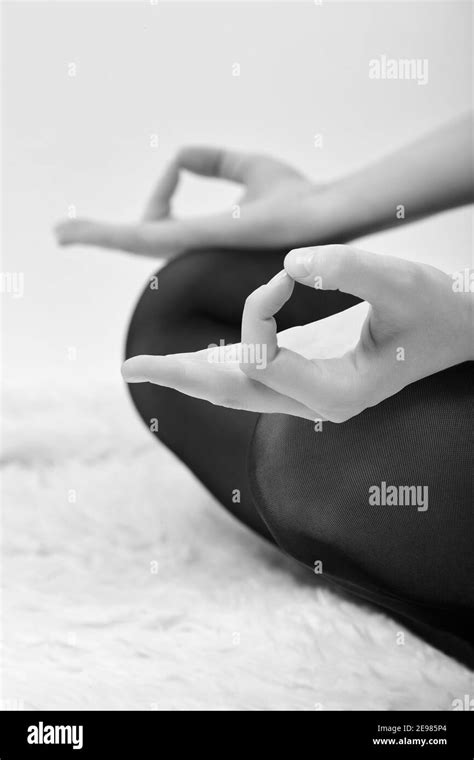 Female Hands In Mudra Gesture On Knees White Background Feet In