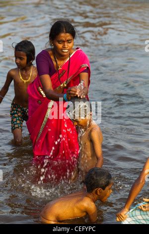 Indian Mother Bathing His Son On The Waters Of Tungabhadra River Hampi
