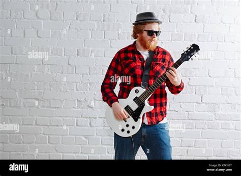 Playing The Guitar Ginger Hipster In White Brick Studio Stock Photo Alamy