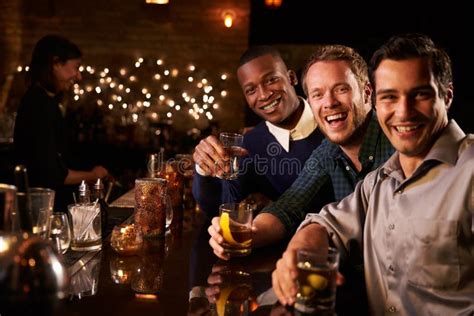 Portrait Of Male Friends Enjoying Night Out At Cocktail Bar Stock Image Image Of Black Drink