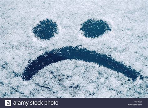 Sad Smiley Emoticon Face Drawn On Snow Covered Glass Winter Season