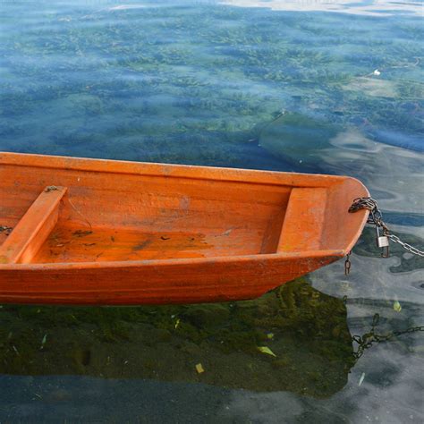Wooden Boat Floating On The Clear Lake Photograph