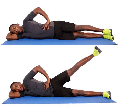 Fit Man Demonstrates How To Do Lying Side Leg Raises While Lying On