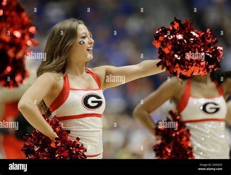 A Georgia Cheerleader Performs During The First Half Of An Ncaa College Basketball Game Against