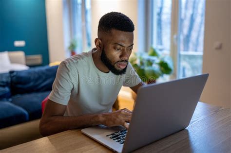Focused African American Guy Freelancer Working On Laptop At Home