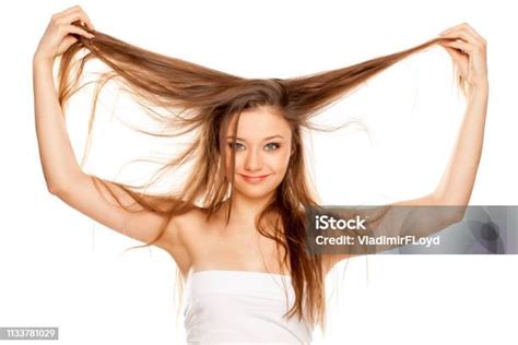 Young Blonde Showing Her Long Straight Hair On White Bckground Stock