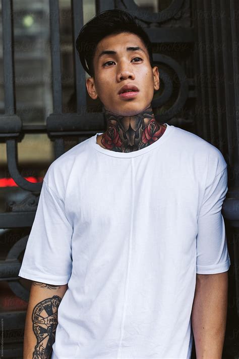 Portrait Of A Young Asian Tattooed Man Standing Outside By