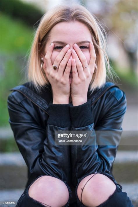 Laughing Caucasian Woman Covering Face With Hands Photo Getty Images