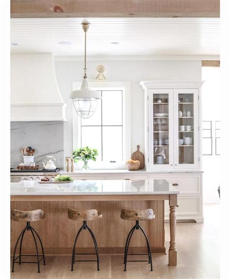 Wood cabinets are a classic feature in any kitchen. Love the combination of white cabinets and warm natural wood in this pretty kitchen by ...