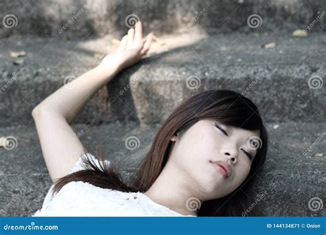 Beautiful Asian Woman Lying Down With Her Eyes Closed Stock Image