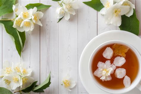 Premium Photo Mug Of Herbal Tea With Petals Of Jasmine Flowers