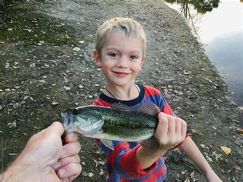 User Generated Content Child Holding Fish Caught While Fishing By