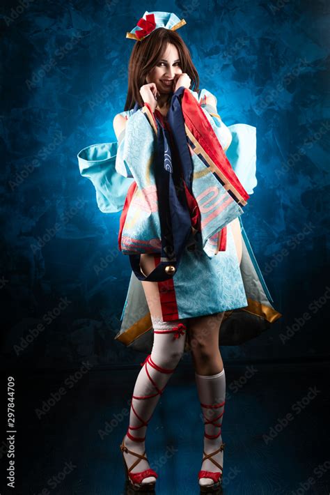 beautiful smiling leggy busty cosplay girl wearing a stylized japanese kimono costume cheerfully